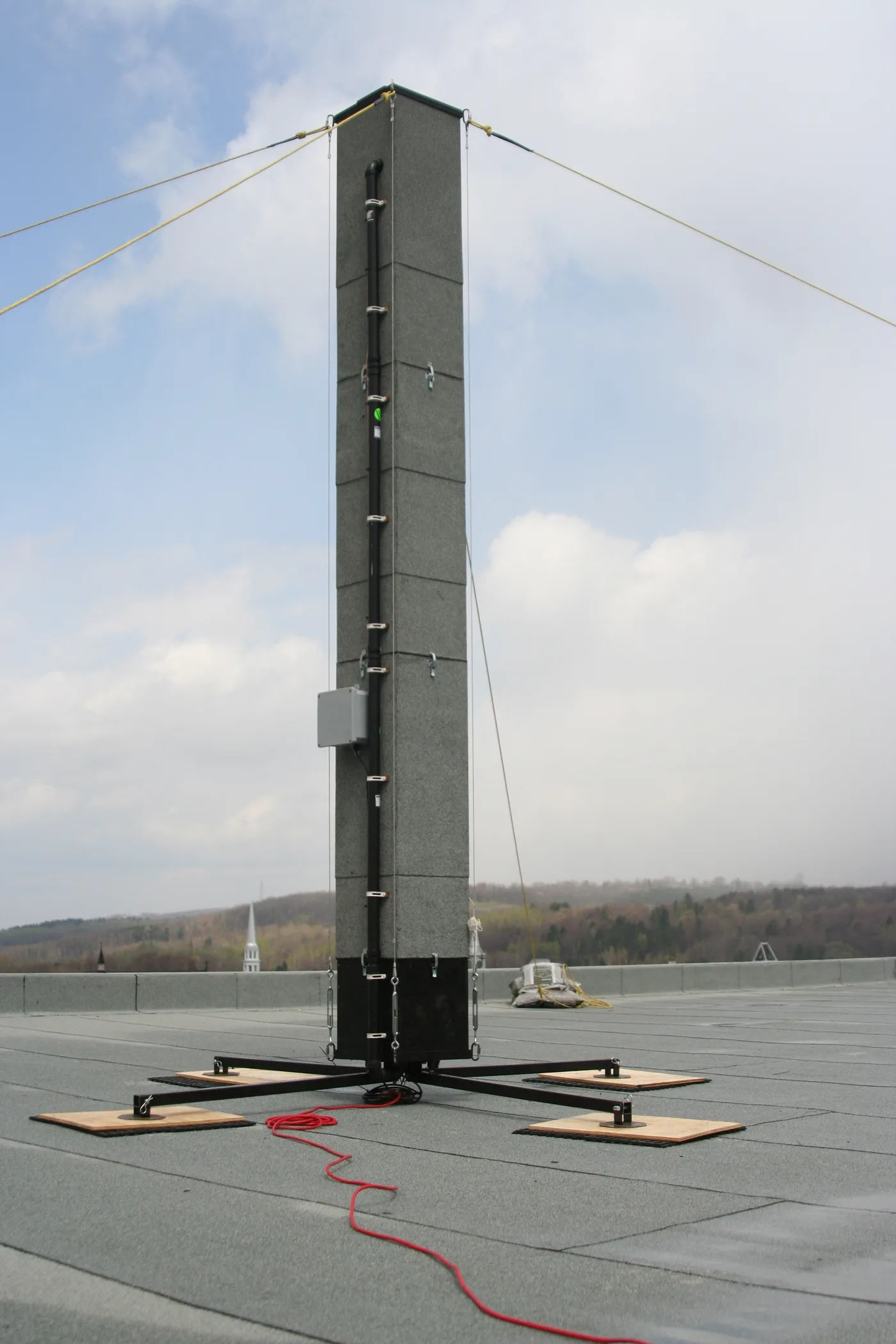 A freestanding chimney swift nesting tower on a rooftop, a purpose-built alternative to an occupied residential chimney